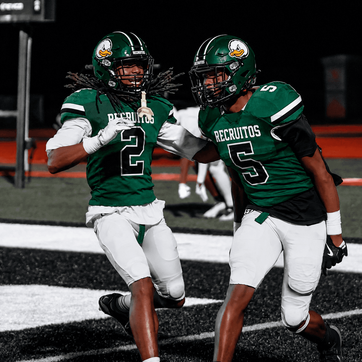 Two RecruitOS football players celebrating in the end zone